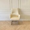 Office chair, leather upholstery, U-shaped steel legs, cream color.