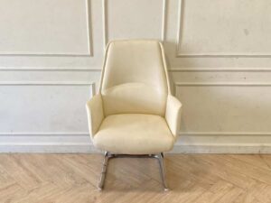 Office chair, leather upholstery, U-shaped steel legs, cream color.