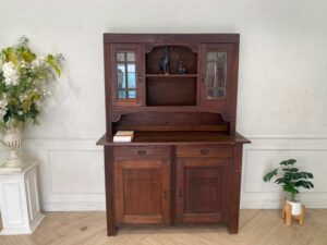 Wooden display cabinet in the hall, antique style, walnut color, European work from Germany.