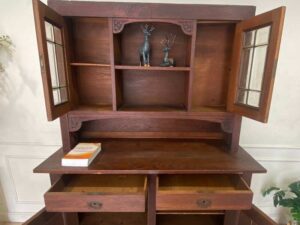 Wooden display cabinet in the hall, antique style, walnut color, European work from Germany.