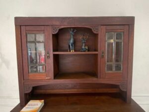 Wooden display cabinet in the hall, antique style, walnut color, European work from Germany.