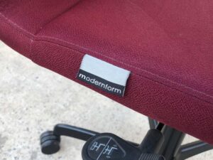 Office chair, red fabric cushion, Modernform brand.