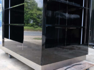 Product shelves, 4 sides, with curtains that can be opened and closed, product labels on 2 sides, wooden frame covered with black high-gloss surface.