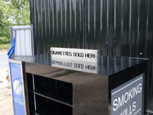 Product shelves, 4 sides, with curtains that can be opened and closed, product labels on 2 sides, wooden frame covered with black high-gloss surface.