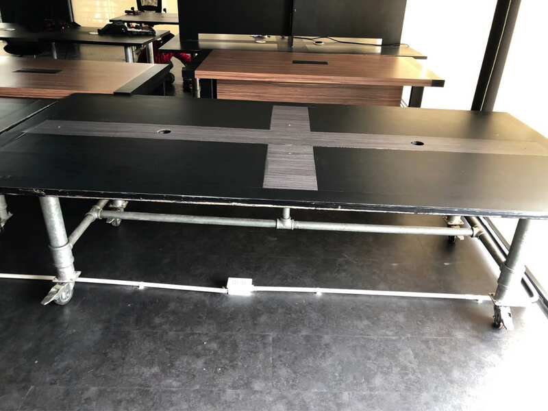 Work desk, 4 seats, steel frame, wooden top, black, with wheels.