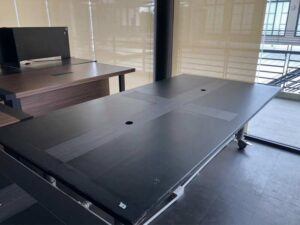 Work desk, 4 seats, steel frame, wooden top, black, with wheels.