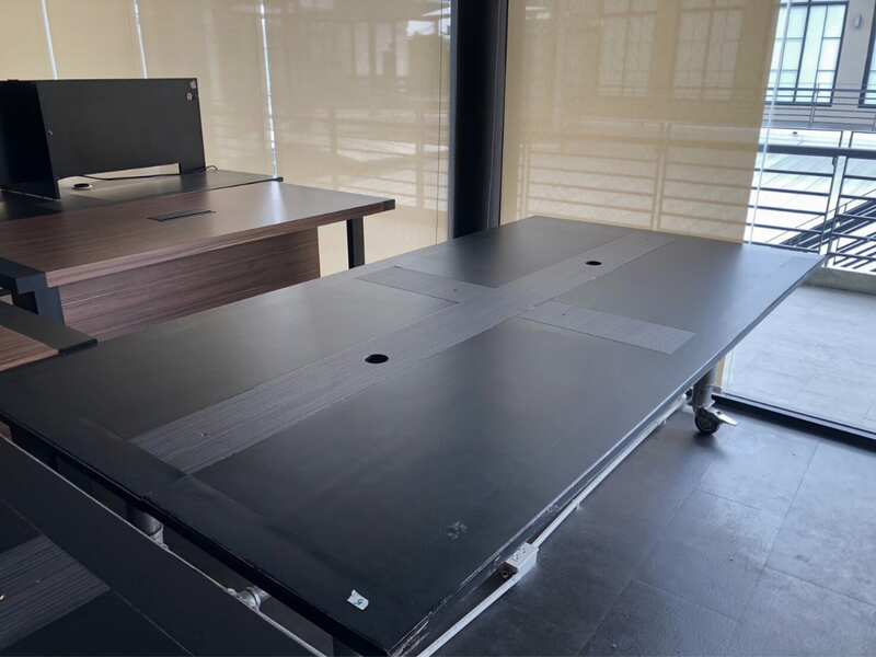Work desk, 4 seats, steel frame, wooden top, black, with wheels.