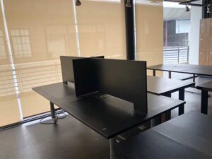 Work desk, 4 seats, steel frame, wooden top, black, with wheels.