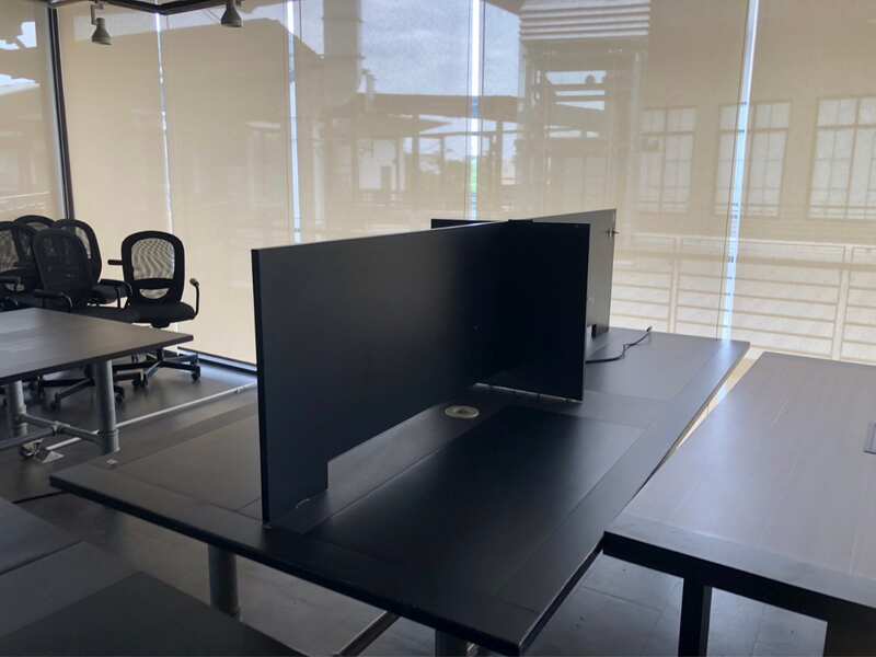 Work desk, 4 seats, steel frame, wooden top, black, with wheels.