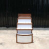 4 wooden product shelves (brown-white) with storage cabinets at the back.