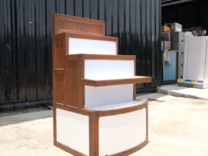 4 wooden product shelves (brown-white) with storage cabinets at the back.