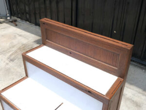 4 wooden product shelves (brown-white) with storage cabinets at the back.