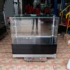 Jewelry cabinet, glass cabinet to display products Rectangular shape, tall mirror, sliding glass door. Wooden base, stainless steel edge