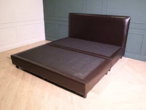 6 foot bed, wooden frame, brown leather covering.