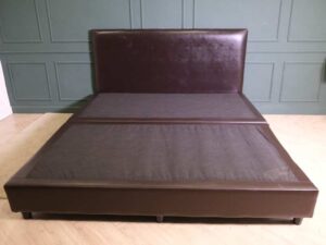 6 foot bed, wooden frame, brown leather covering.