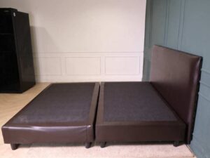 6 foot bed, wooden frame, brown leather covering.