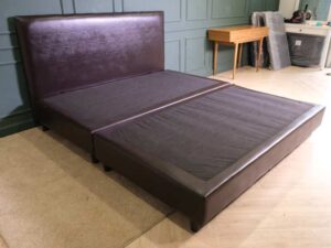6 foot bed, wooden frame, brown leather covering.