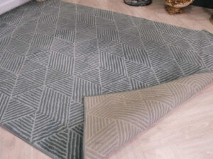 Fur carpet for the living room, gray color, triangle pattern