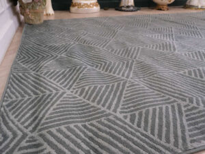 Fur carpet for the living room, gray color, triangle pattern