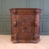 Carved wooden corner cabinet with 1 door that opens. European work from Germany.