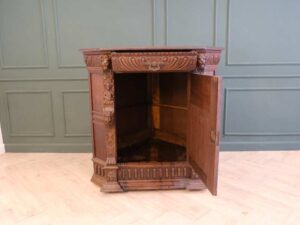 Carved wooden corner cabinet with 1 door that opens. European work from Germany.