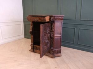 Carved wooden corner cabinet with 1 door that opens. European work from Germany.