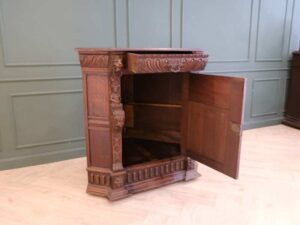 Carved wooden corner cabinet with 1 door that opens. European work from Germany.