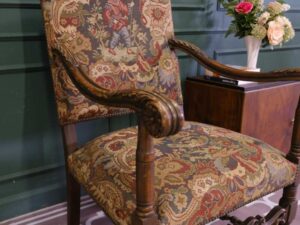 Carved chair, Louis style, fabric cushion with men's floral pattern. European work comes from Germany.