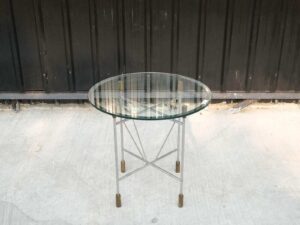 Round glass top table, cut glass, steel legs, hotel grade work.