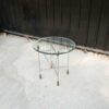Round glass top table, cut glass, steel legs, hotel grade work.