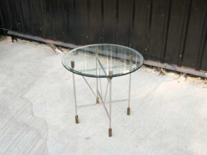 Round glass top table, cut glass, steel legs, hotel grade work.