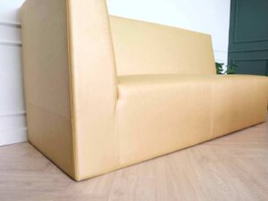 Three-seater leather sofa, beautiful shade, wooden frame, golden yellow color.