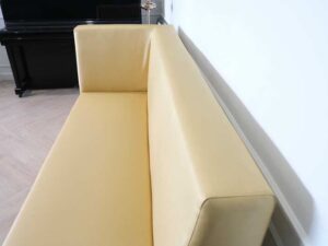 Three-seater leather sofa, beautiful shade, wooden frame, golden yellow color.