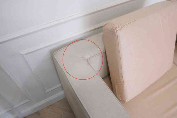 L-shaped sofa, 3-seater sofa, thick cream-pink fabric seats, wooden frame.