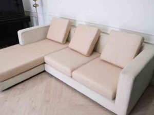 L-shaped sofa, 3-seater sofa, thick cream-pink fabric seats, wooden frame.
