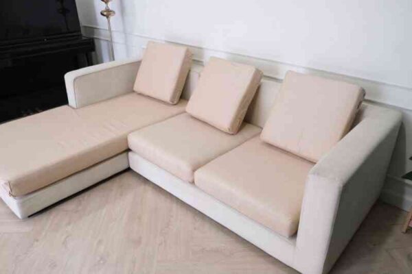 L-shaped sofa, 3-seater sofa, thick cream-pink fabric seats, wooden frame.