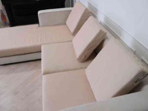 L-shaped sofa, 3-seater sofa, thick cream-pink fabric seats, wooden frame.