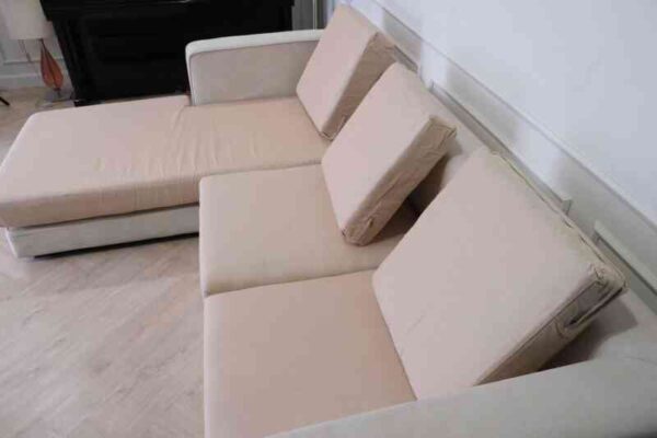 L-shaped sofa, 3-seater sofa, thick cream-pink fabric seats, wooden frame.