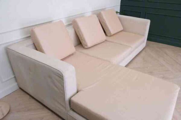 L-shaped sofa, 3-seater sofa, thick cream-pink fabric seats, wooden frame.