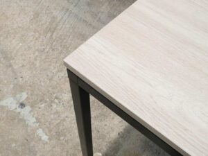 Multipurpose table, wood pattern top, black steel leg frame.