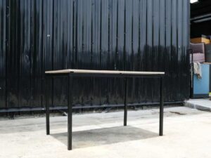 Multipurpose table, wood pattern top, black steel leg frame.