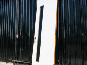 Wooden door with 2 different colored glass panels inside and outside, brown-white.