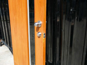 Wooden door with 2 different colored glass panels inside and outside, brown-white.
