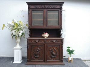 Tall buffet cabinet, carved wood with bird pattern. European work comes from Germany.