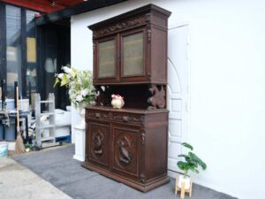 Tall buffet cabinet, carved wood with bird pattern. European work comes from Germany.