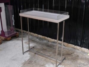 Tall wooden product display tray, attached to a clear acrylic frame. Product shelves, steel leg frame