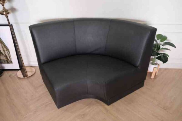 Curved leather sofa, beautiful shadow, wooden frame, black color.