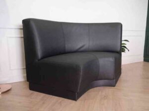 Curved leather sofa, beautiful shadow, wooden frame, black color.