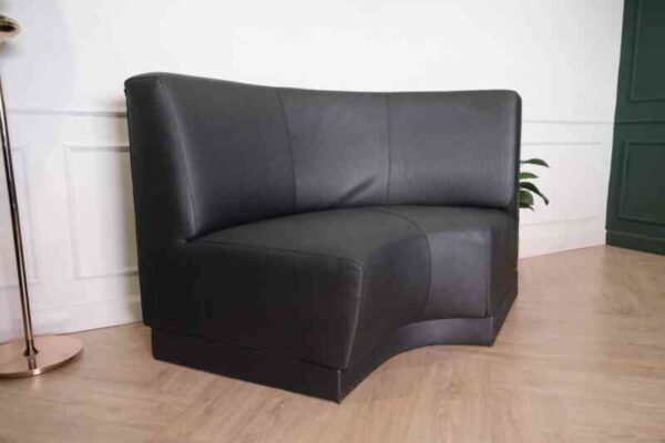 Curved leather sofa, beautiful shadow, wooden frame, black color.