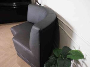 Curved leather sofa, beautiful shadow, wooden frame, black color.
